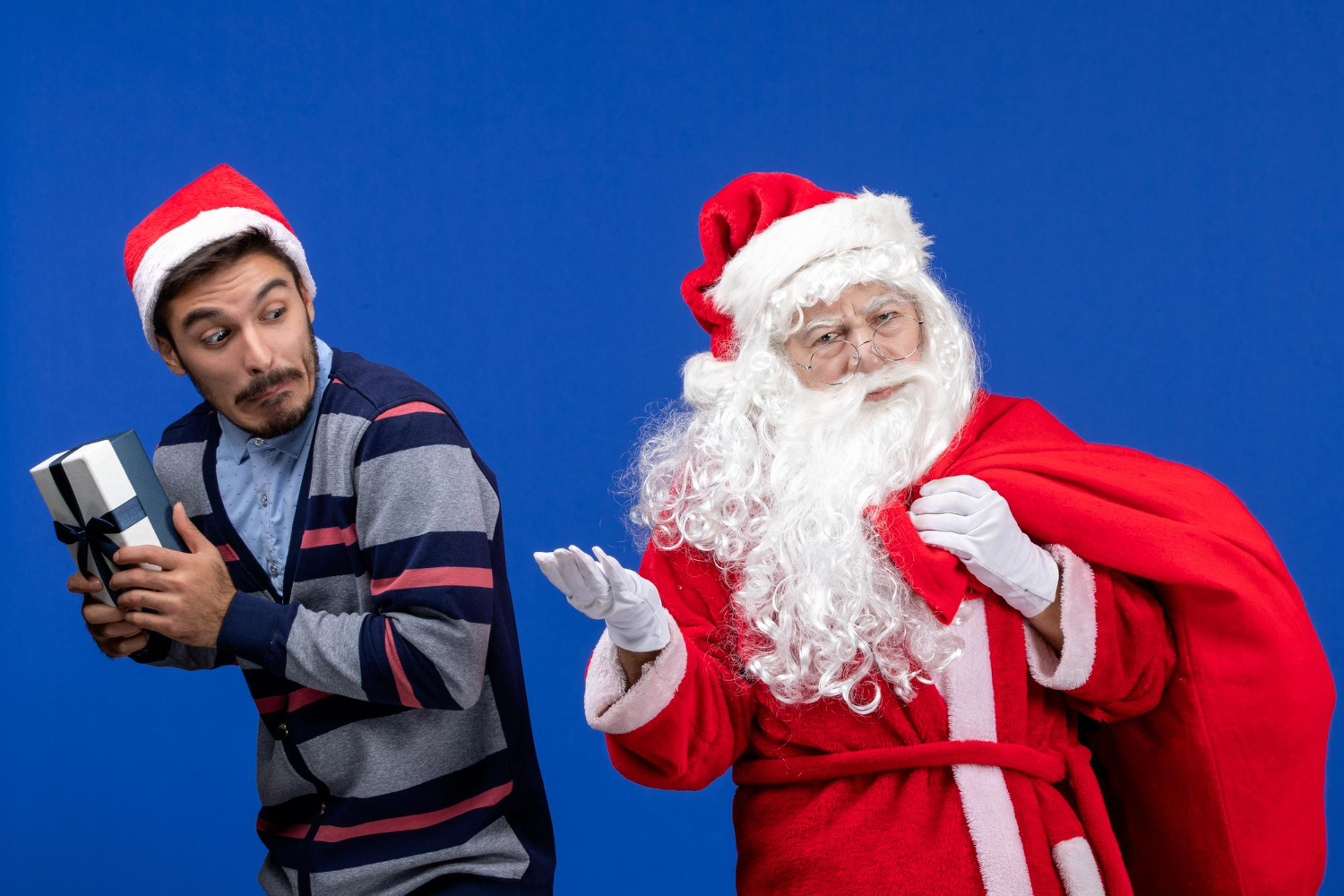 A thief stealing one of Santa’s presents and trying to get away A thief stealing one of Santa’s presents and trying to get away